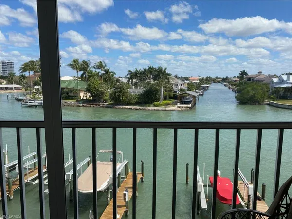 a view of a balcony with lake view and sitting space