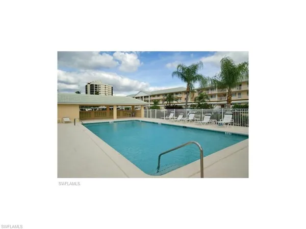 a picture of a living room with a sink and breakfast area