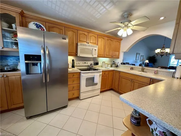 a kitchen with stainless steel appliances granite countertop a sink a stove and refrigerator