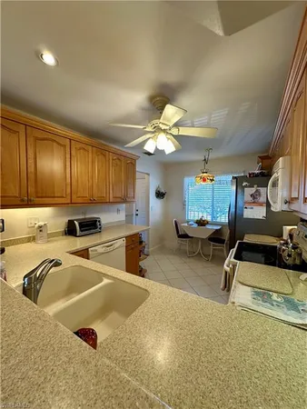 a kitchen with stainless steel appliances granite countertop a sink a stove and cabinets