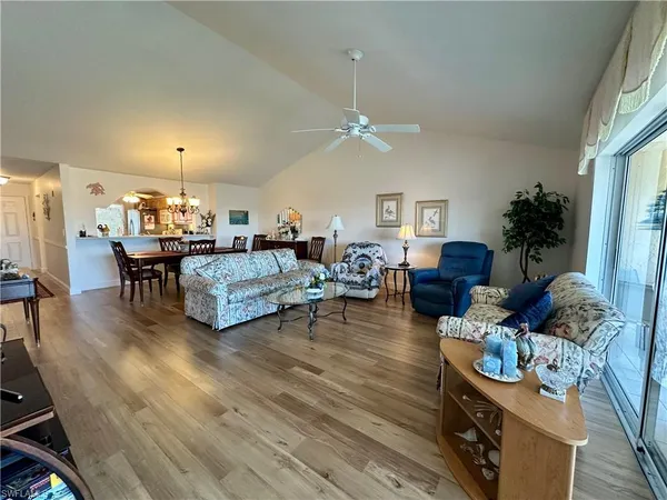 a living room with furniture and a chandelier