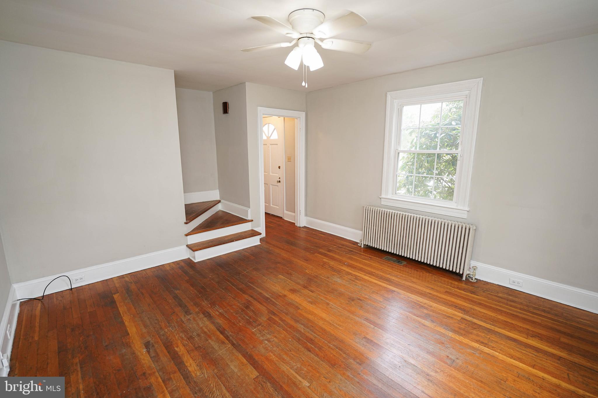 234 North Boulevard, Unit A Salisbury, MD 21801 - Photo 12 of 38 an empty room with wooden floor chandelier fan and windows