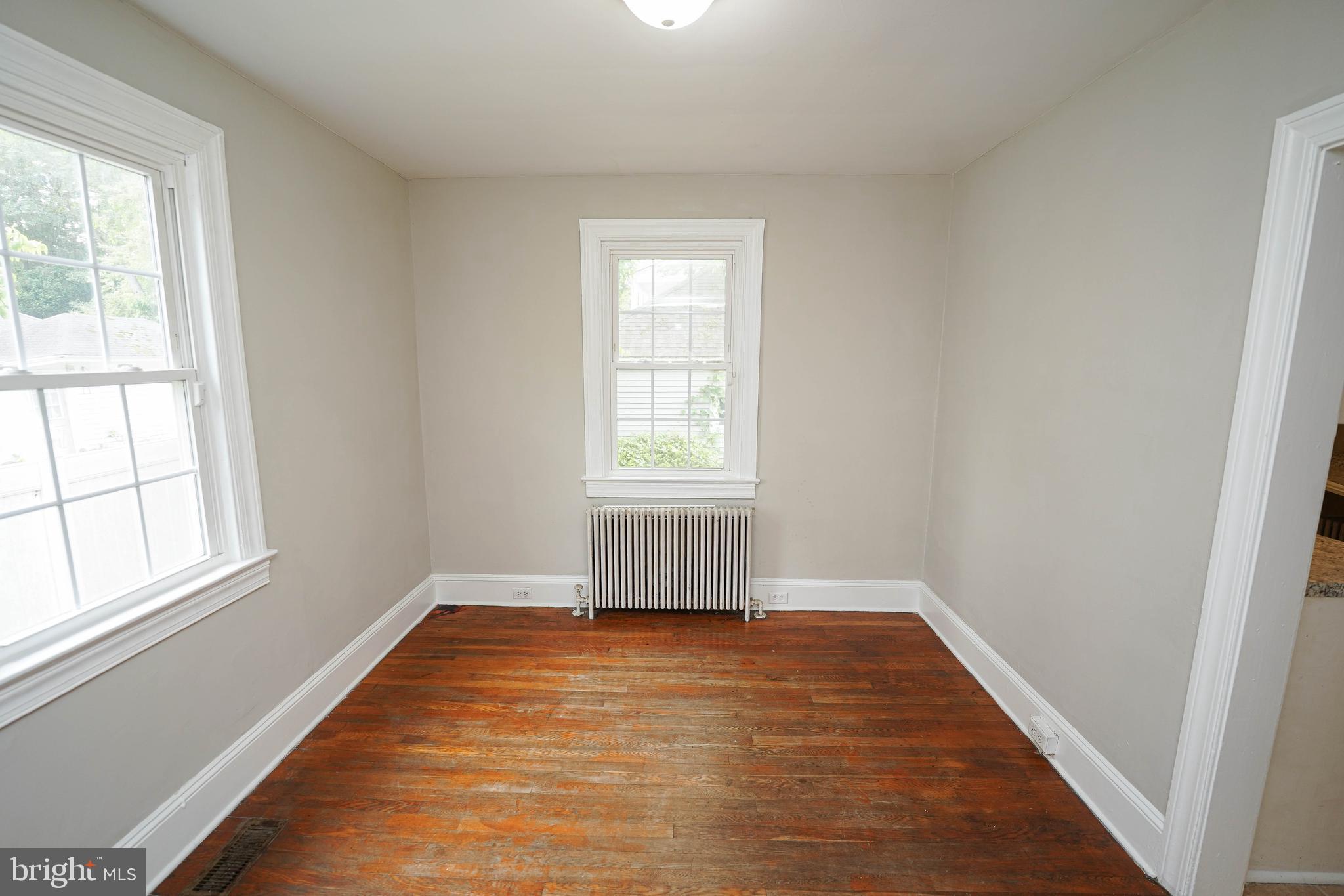 234 North Boulevard, Unit A Salisbury, MD 21801 - Photo 13 of 38 an empty room with wooden floor and windows