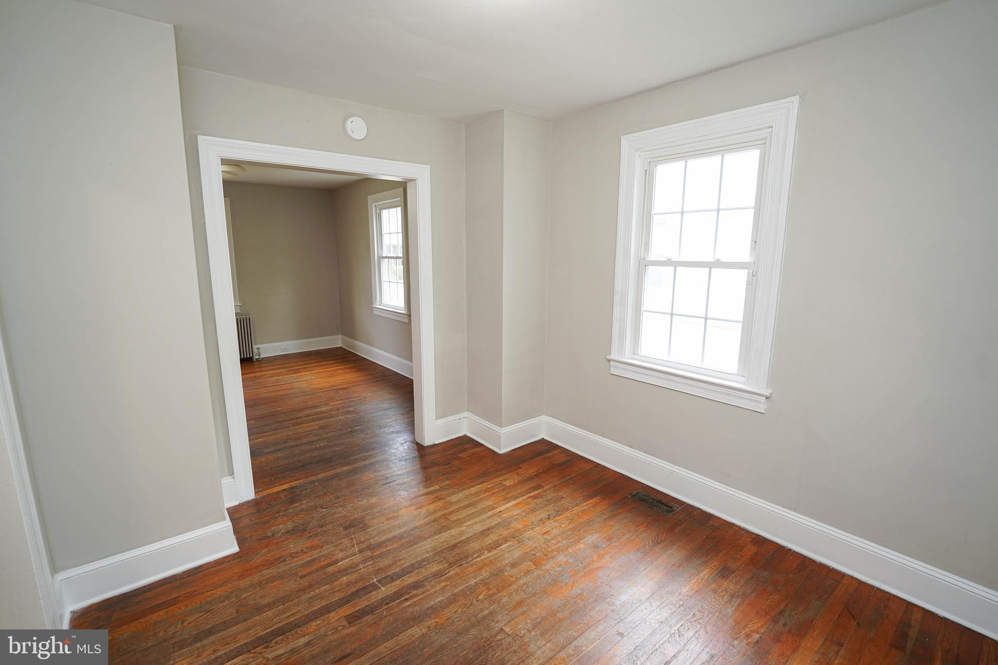 234 North Boulevard, Unit A Salisbury, MD 21801 - Photo 15 of 38 an empty room with wooden floor and windows