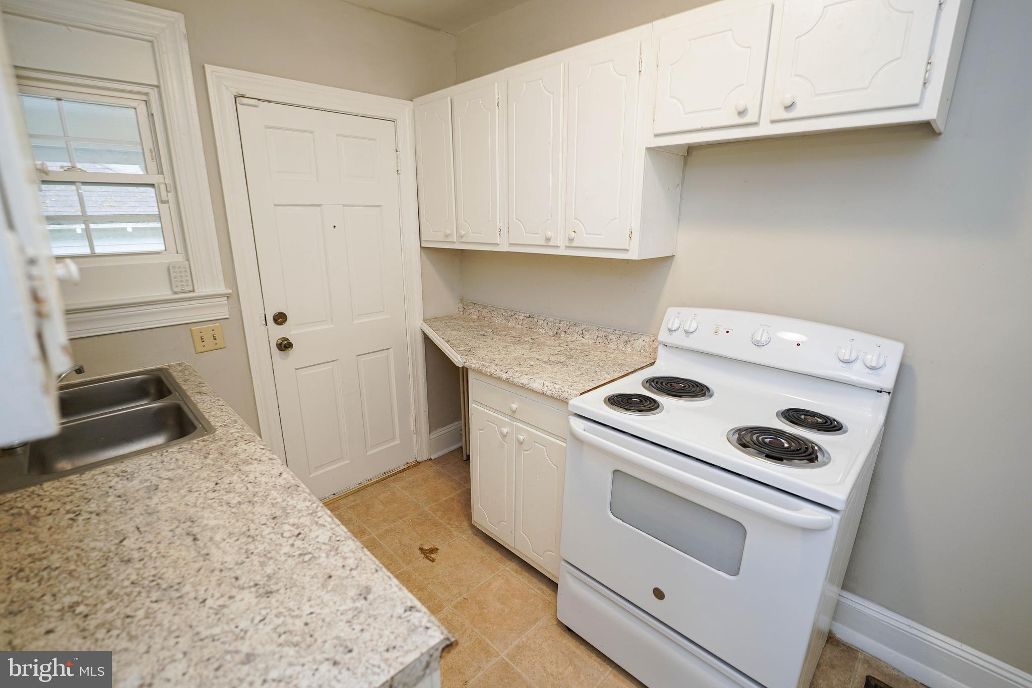234 North Boulevard, Unit A Salisbury, MD 21801 - Photo 16 of 38 a kitchen with white cabinets and white appliances