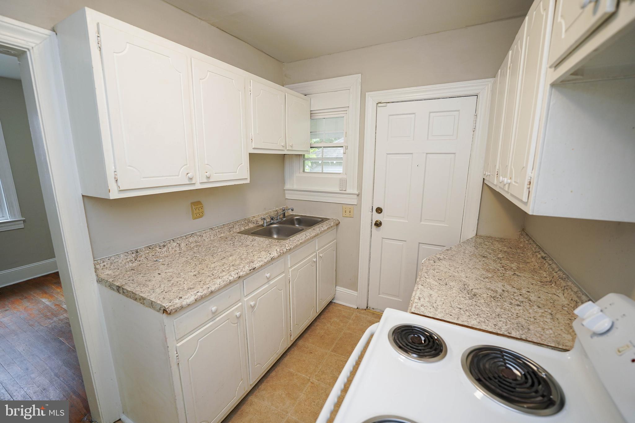 234 North Boulevard, Unit A Salisbury, MD 21801 - Photo 17 of 38 a kitchen with a sink a stove and cabinets