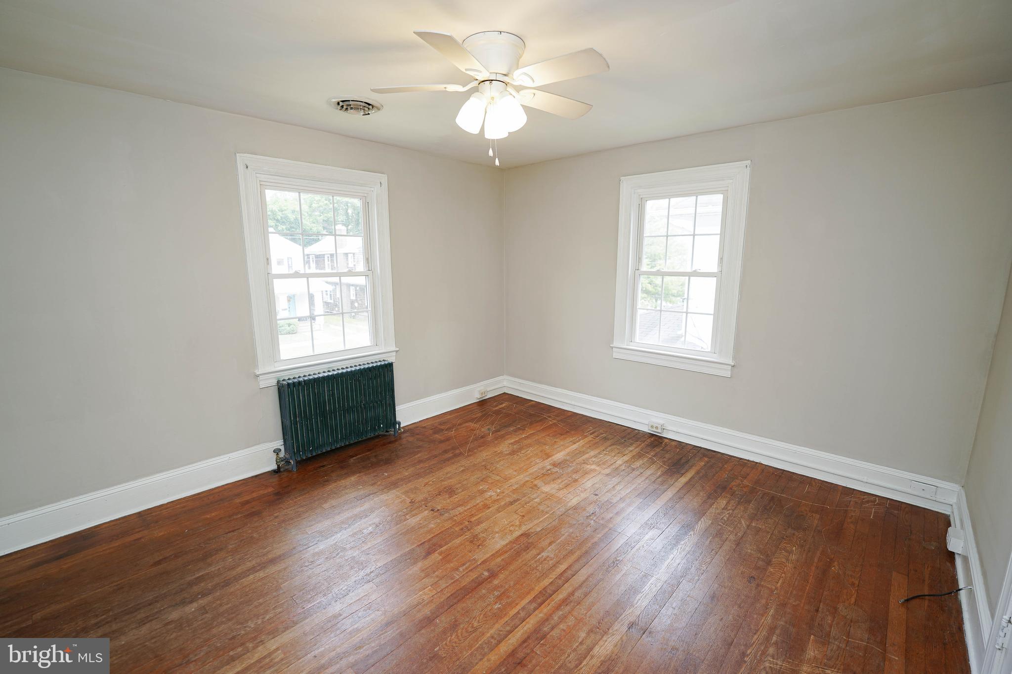234 North Boulevard, Unit A Salisbury, MD 21801 - Photo 25 of 38 an empty room with wooden floor ceiling fan and windows
