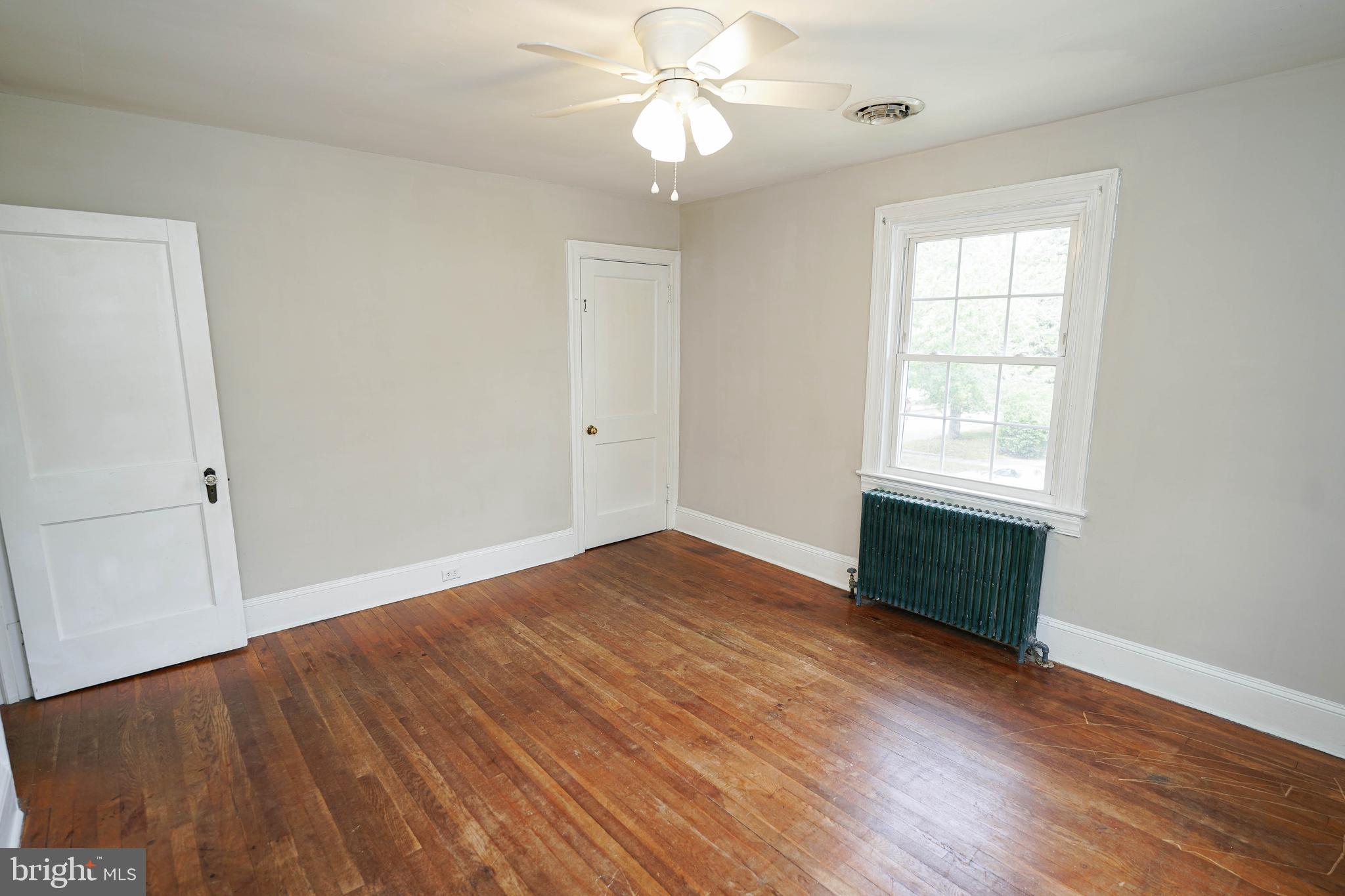234 North Boulevard, Unit A Salisbury, MD 21801 - Photo 26 of 38 a view of an empty room with wooden floor and a window