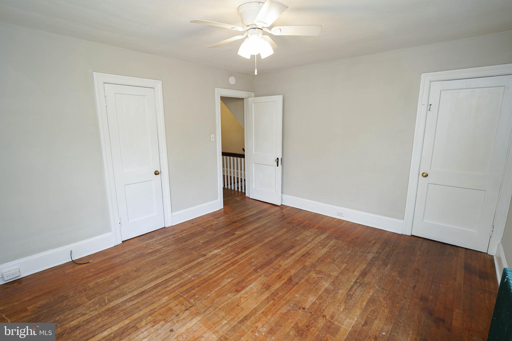 234 North Boulevard, Unit A Salisbury, MD 21801 - Photo 27 of 38 a view of an empty room with wooden floor and a ceiling fan