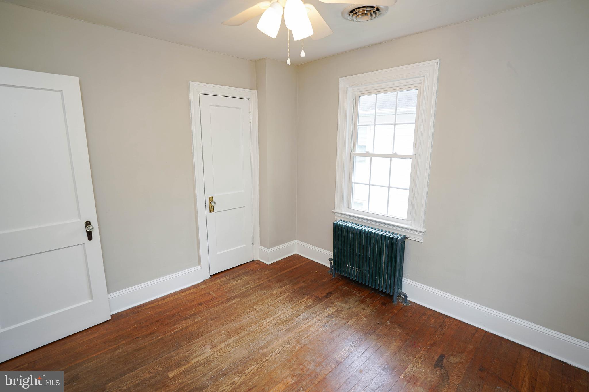 234 North Boulevard, Unit A Salisbury, MD 21801 - Photo 32 of 38 an empty room with wooden floor cabinet and windows
