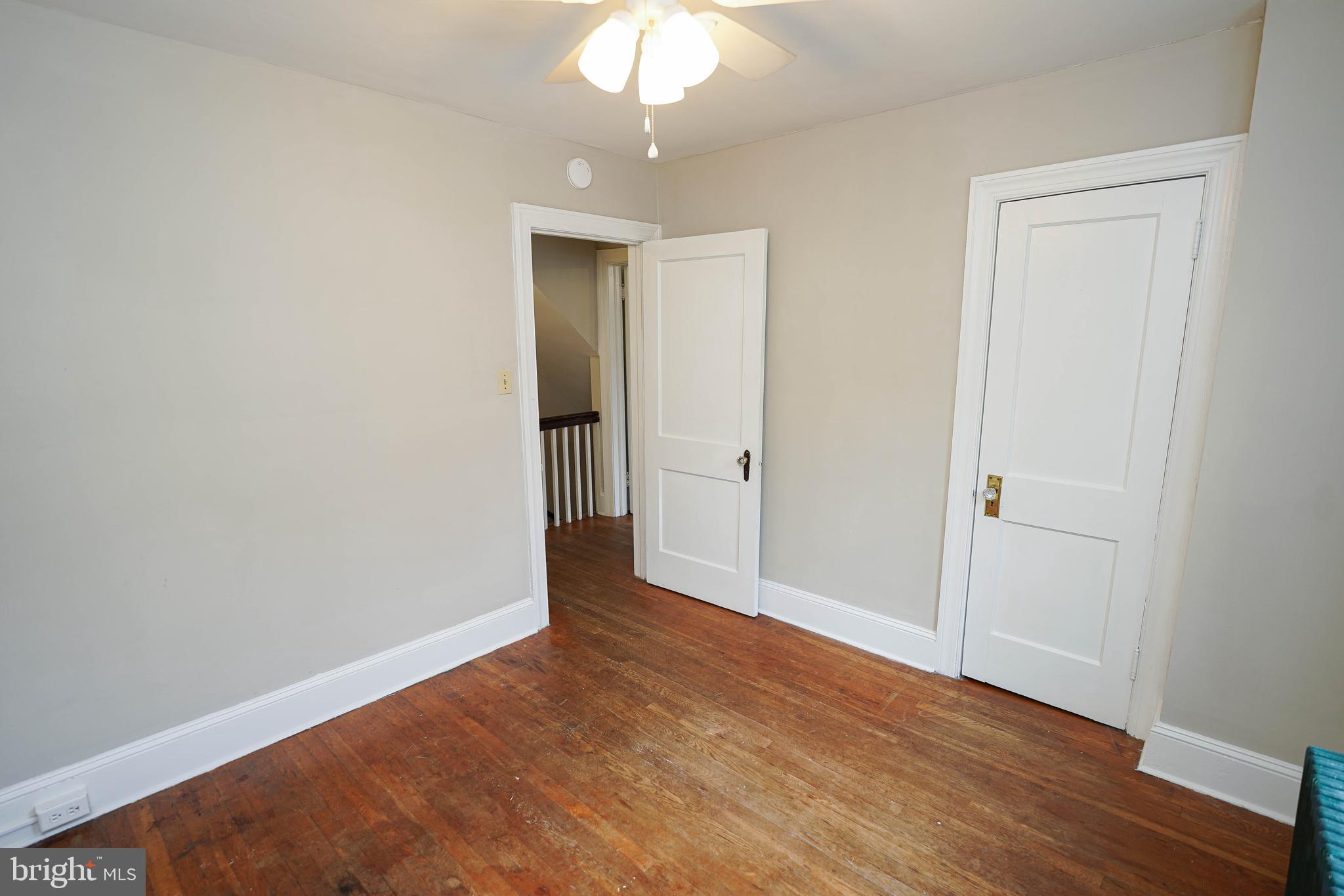 234 North Boulevard, Unit A Salisbury, MD 21801 - Photo 33 of 38 an empty room with wooden floor and a ceiling fan