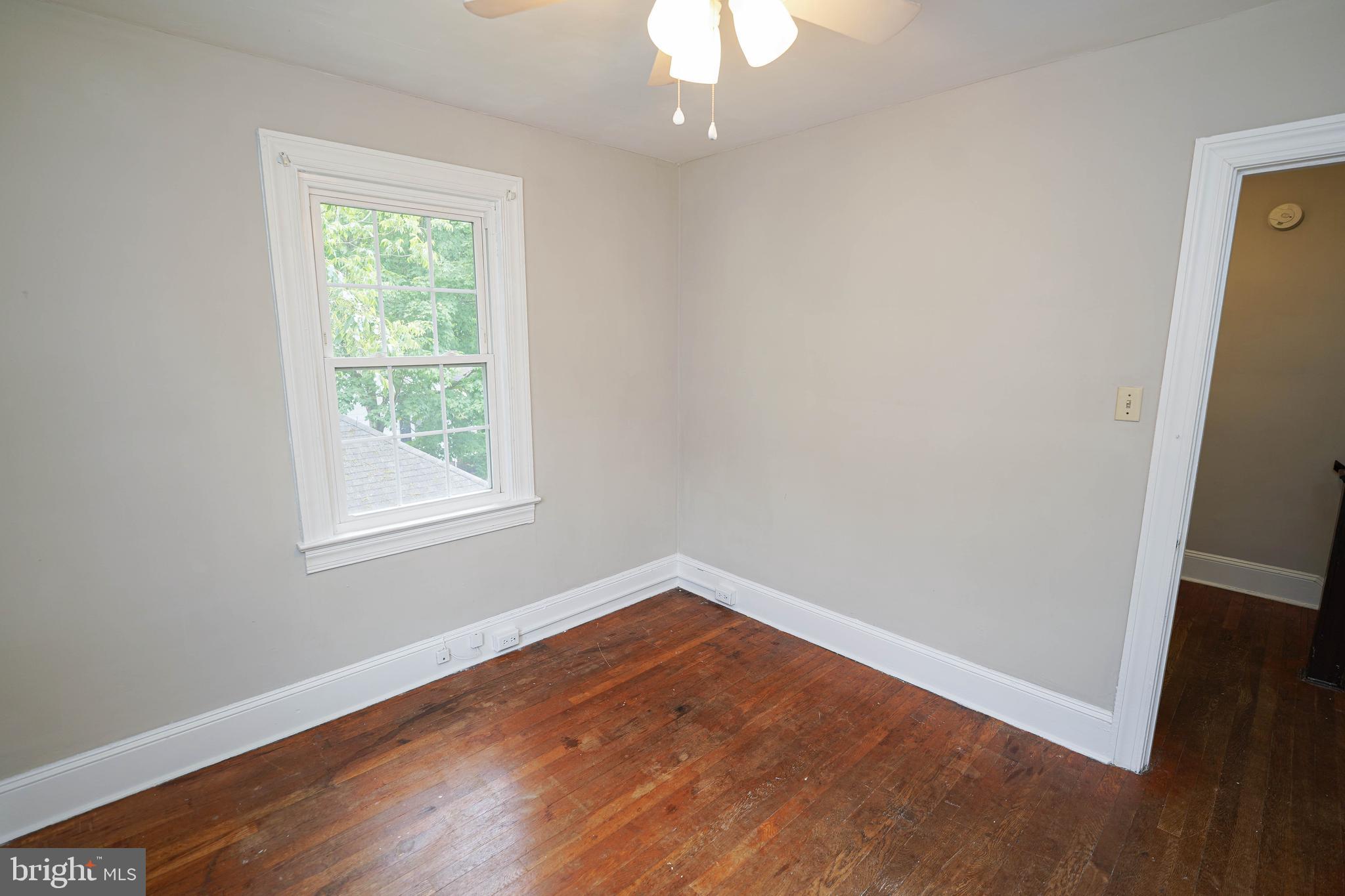 234 North Boulevard, Unit A Salisbury, MD 21801 - Photo 34 of 38 an empty room with wooden floor and windows