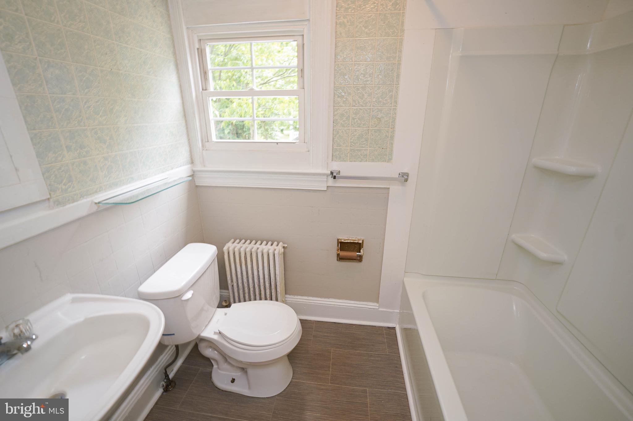 234 North Boulevard, Unit A Salisbury, MD 21801 - Photo 36 of 38 a white toilet sitting next to a bath tub