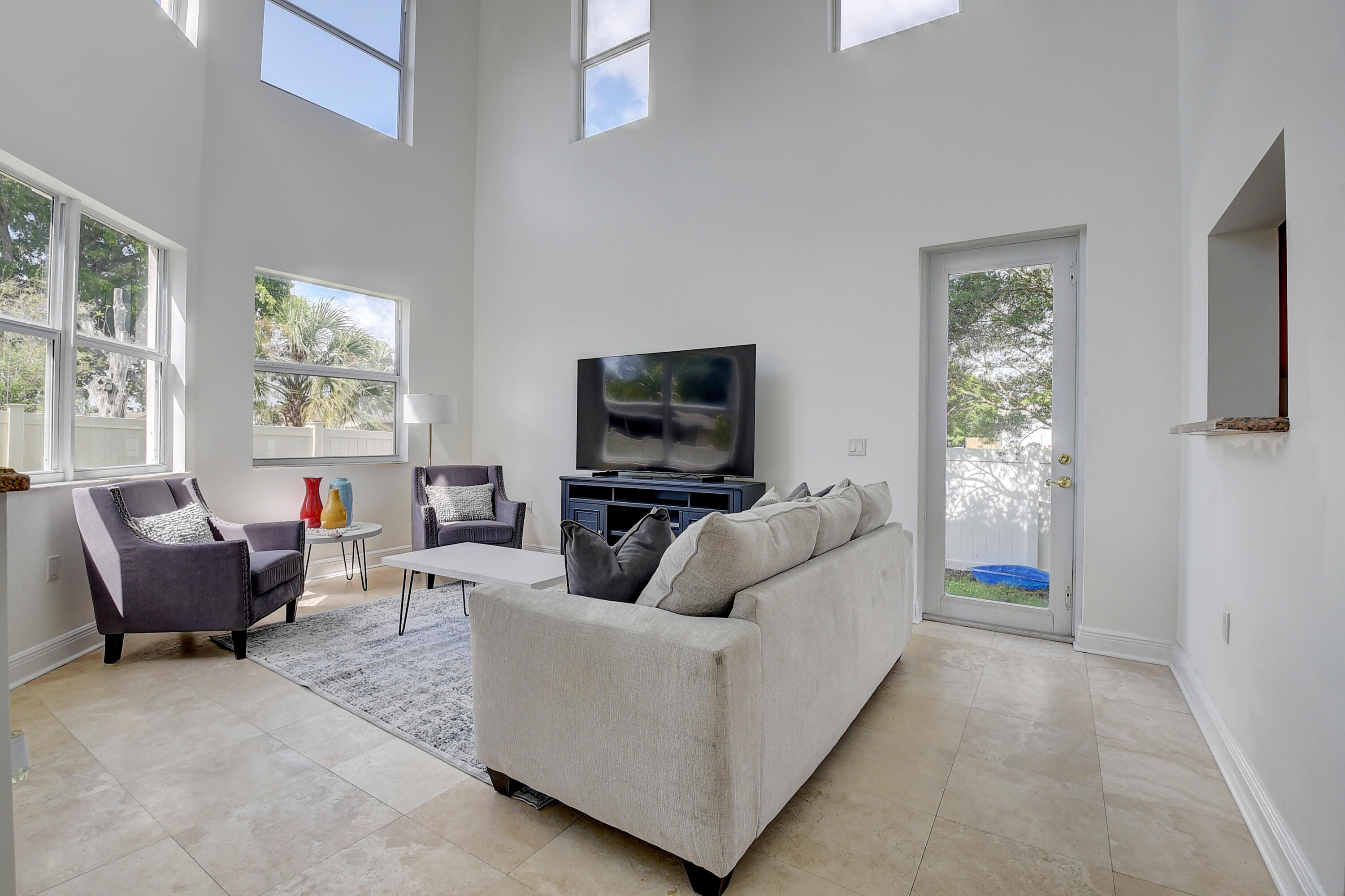 9058 Southwest 4th Street Boca Raton, FL 33433 - Photo 12 of 53 a living room with furniture and a flat screen tv