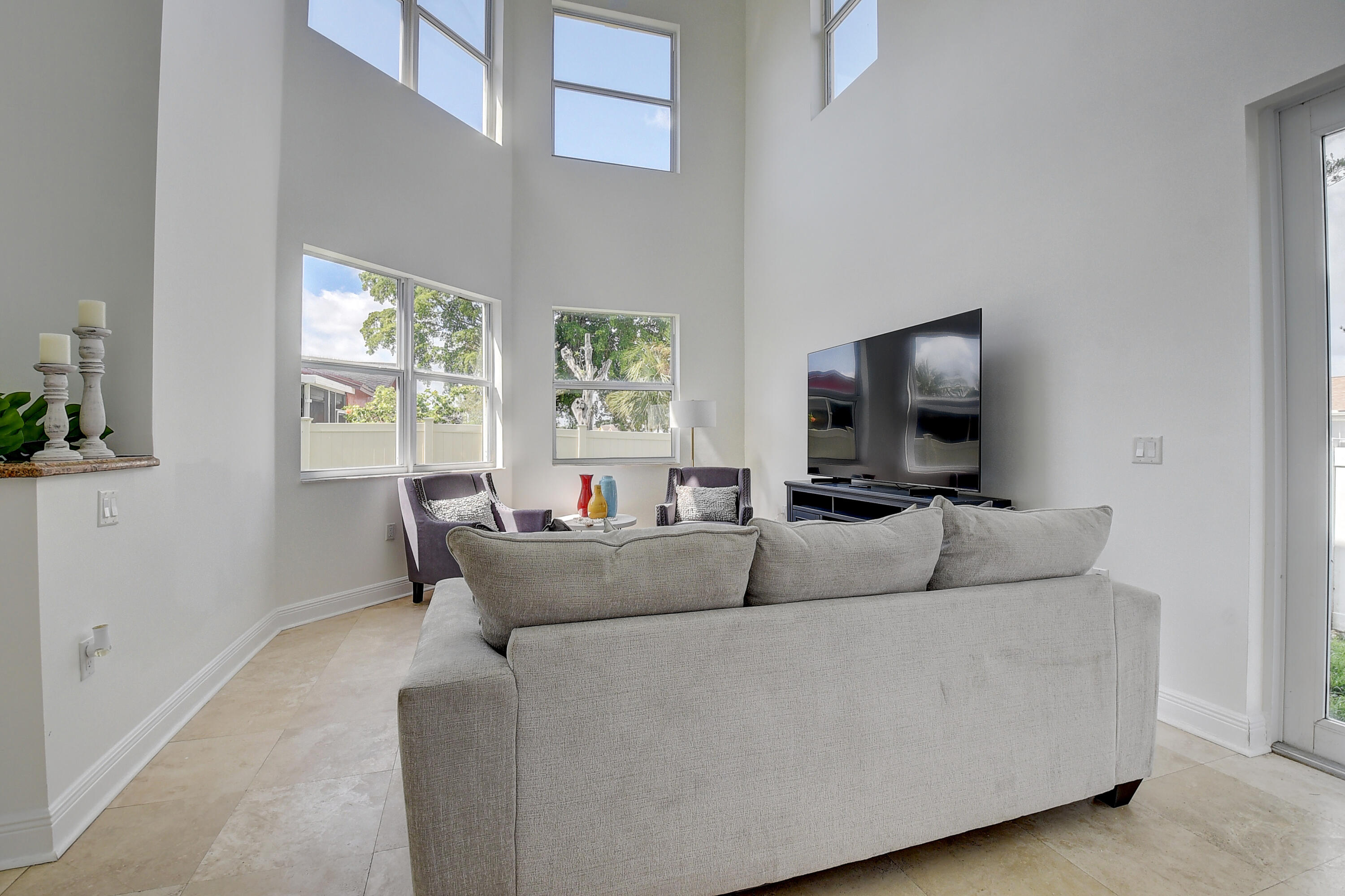 9058 Southwest 4th Street Boca Raton, FL 33433 - Photo 14 of 53 a living room with furniture and a flat screen tv