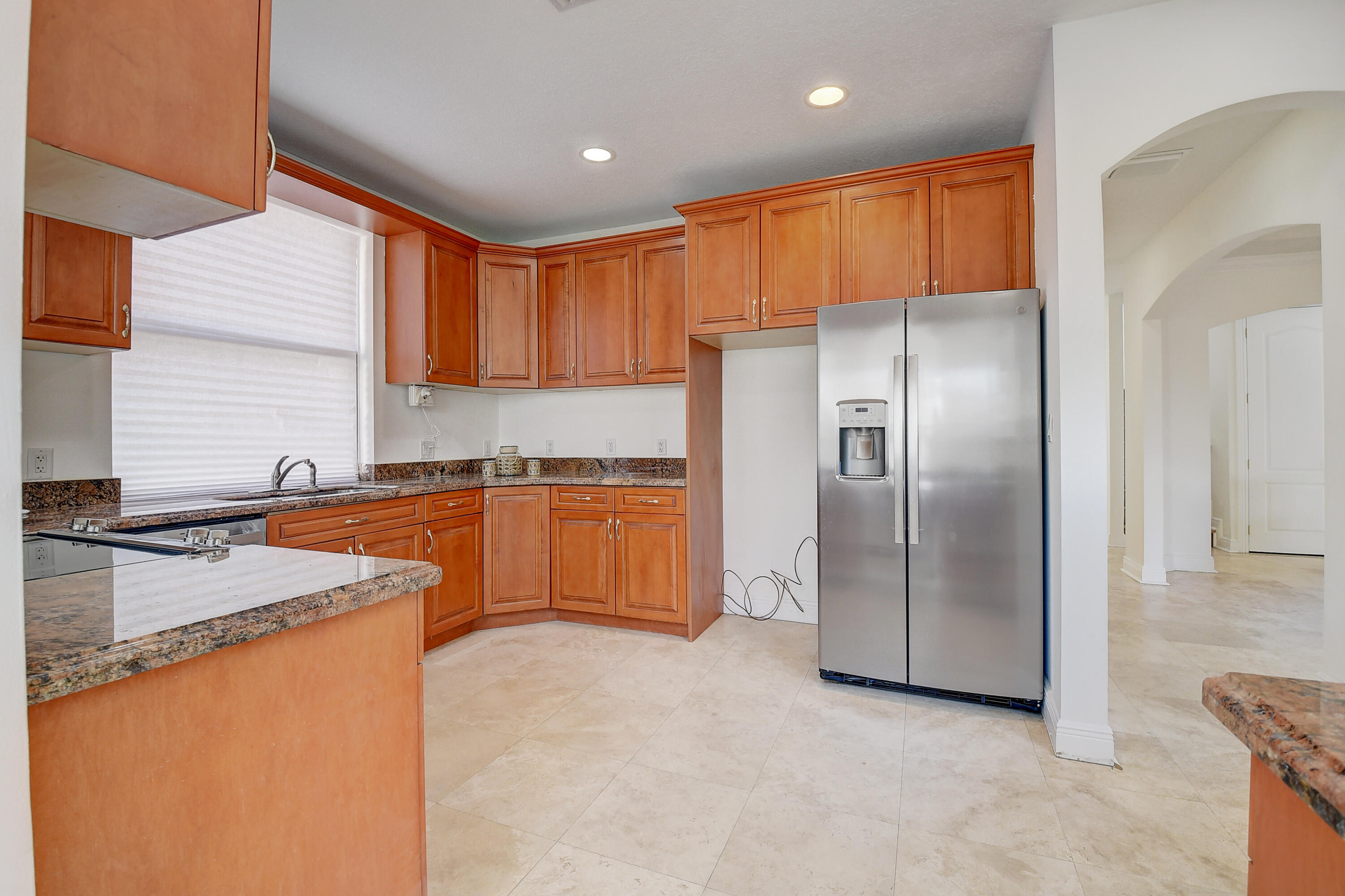 9058 Southwest 4th Street Boca Raton, FL 33433 - Photo 18 of 53 a kitchen with stainless steel appliances granite countertop a refrigerator a sink and a stove