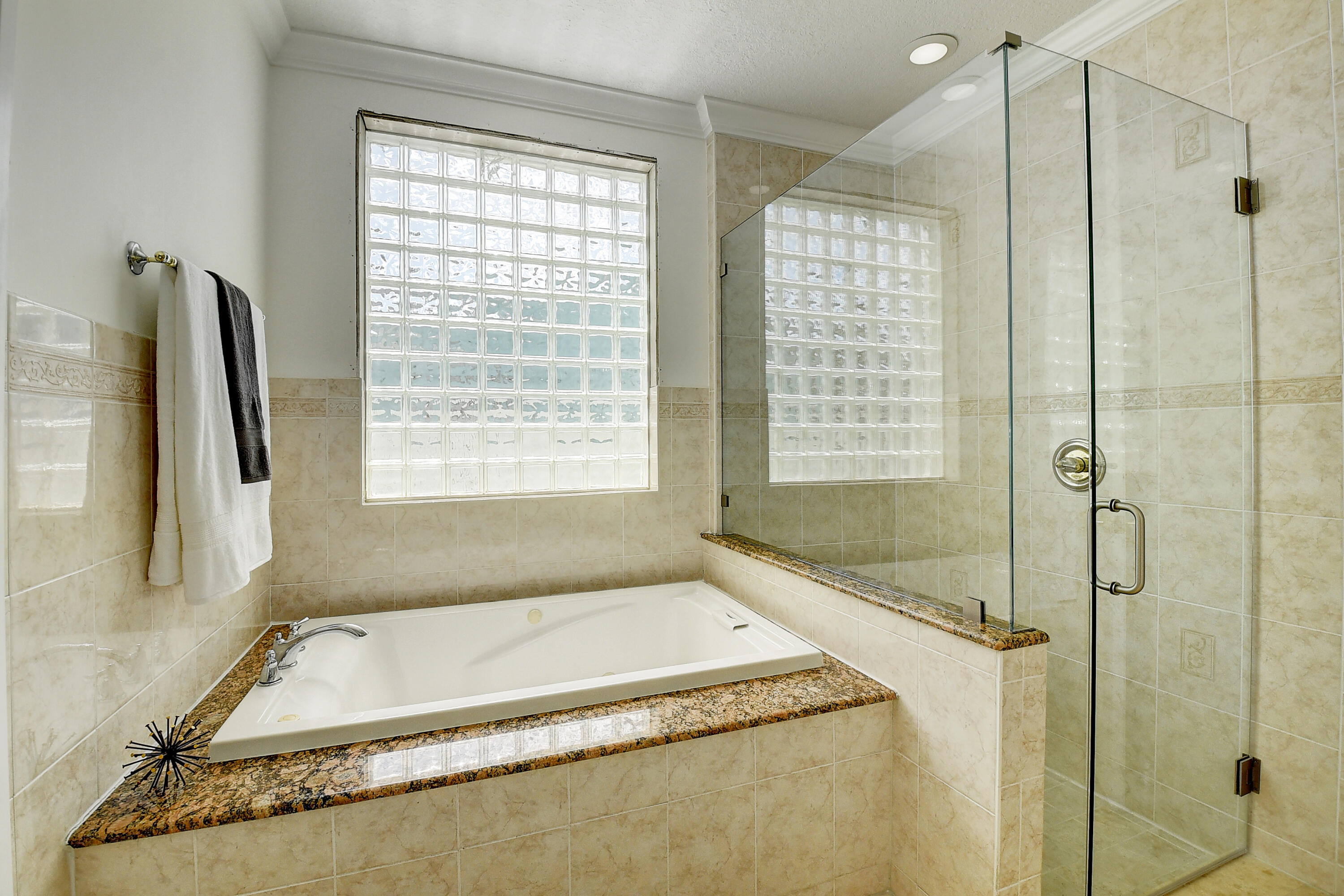 9058 Southwest 4th Street Boca Raton, FL 33433 - Photo 24 of 53 a bathroom with a tub a sink and a shower