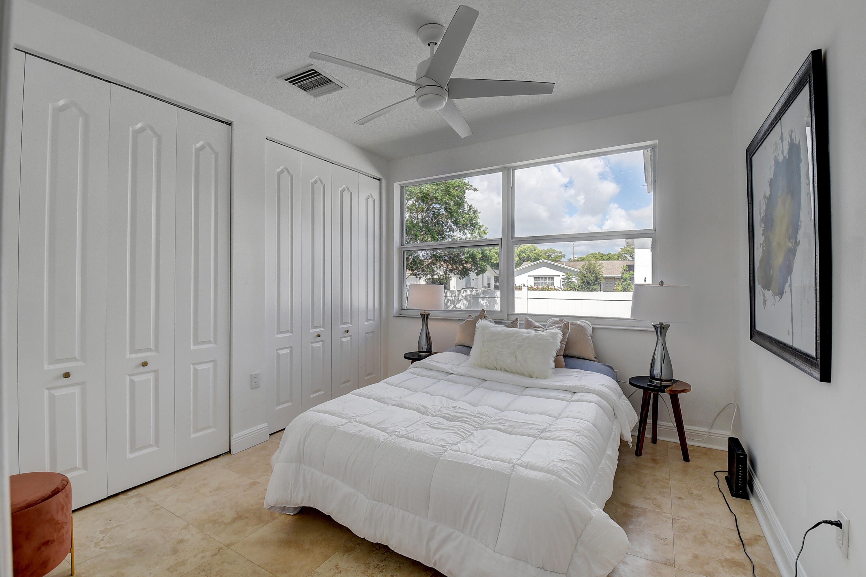 9058 Southwest 4th Street Boca Raton, FL 33433 - Photo 27 of 53 a bedroom with a large bed and a window