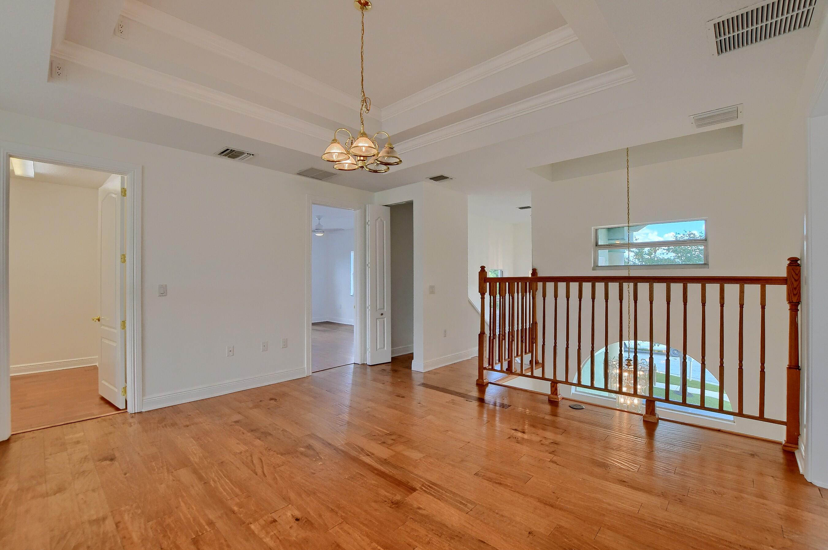 9058 Southwest 4th Street Boca Raton, FL 33433 - Photo 30 of 53 a view of a livingroom with wooden floor and chandelier