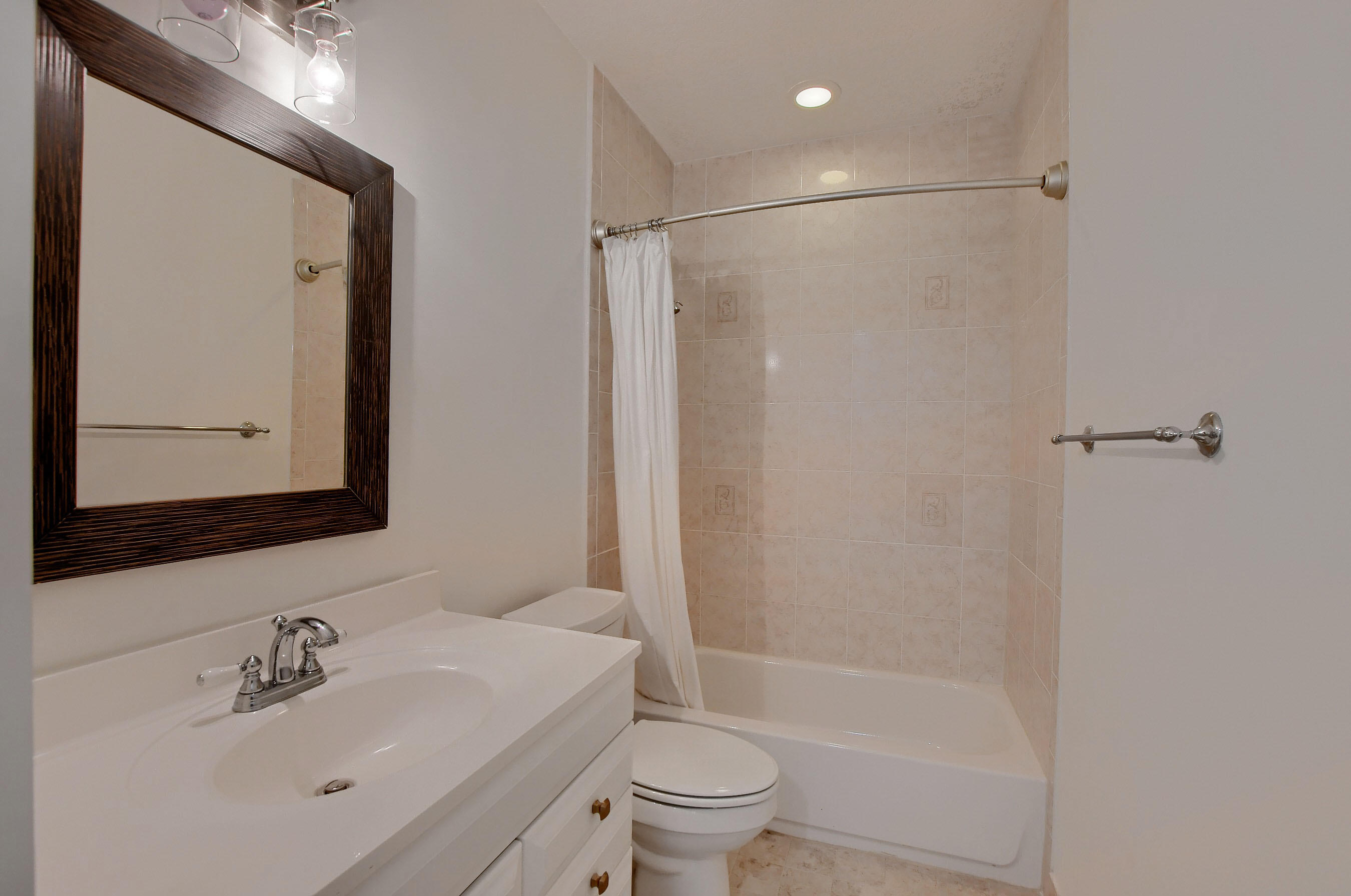 9058 Southwest 4th Street Boca Raton, FL 33433 - Photo 34 of 53 a bathroom with a bathtub shower sink vanity and toilet