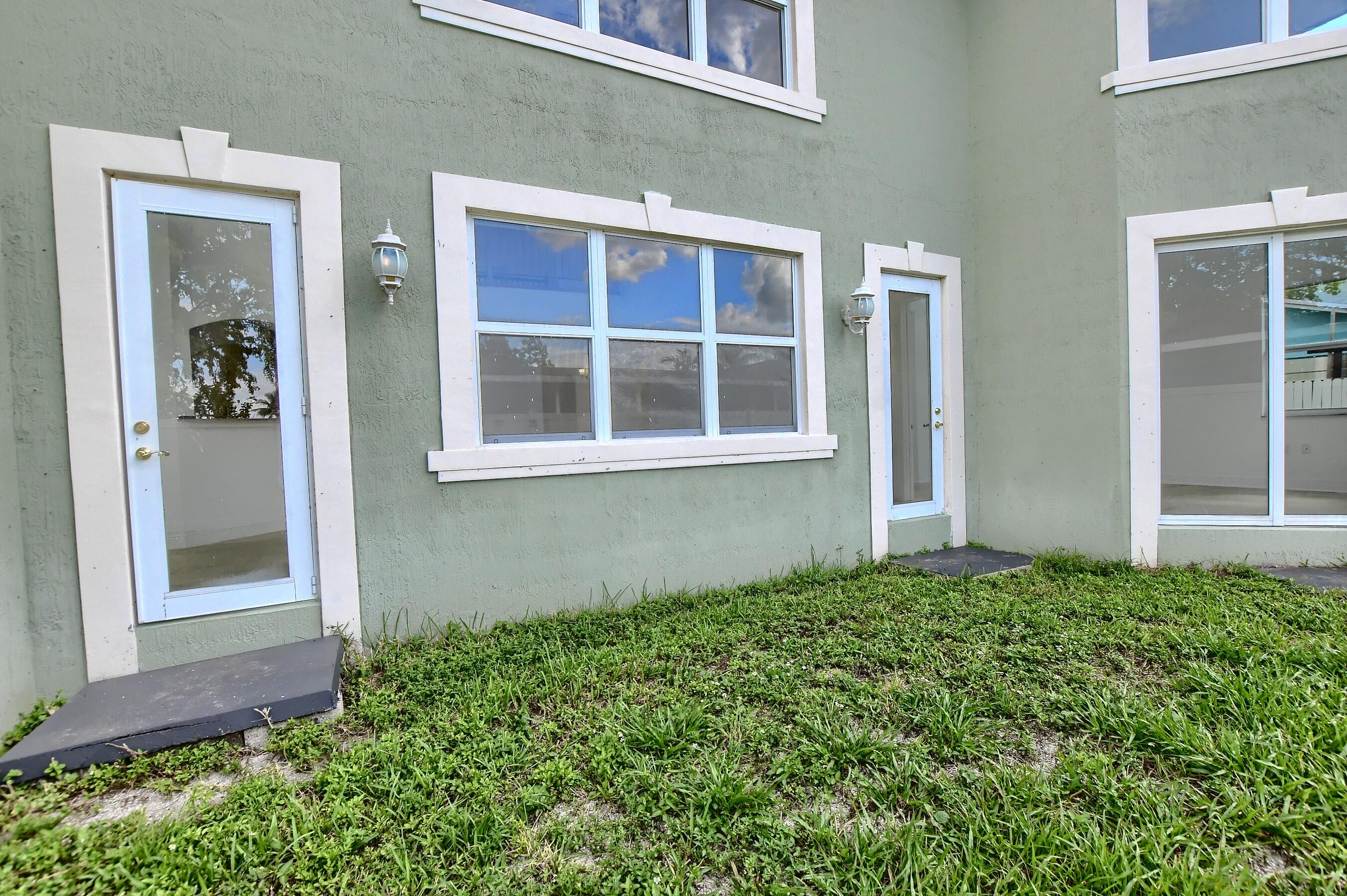 9058 Southwest 4th Street Boca Raton, FL 33433 - Photo 41 of 53 front view of a house with a yard