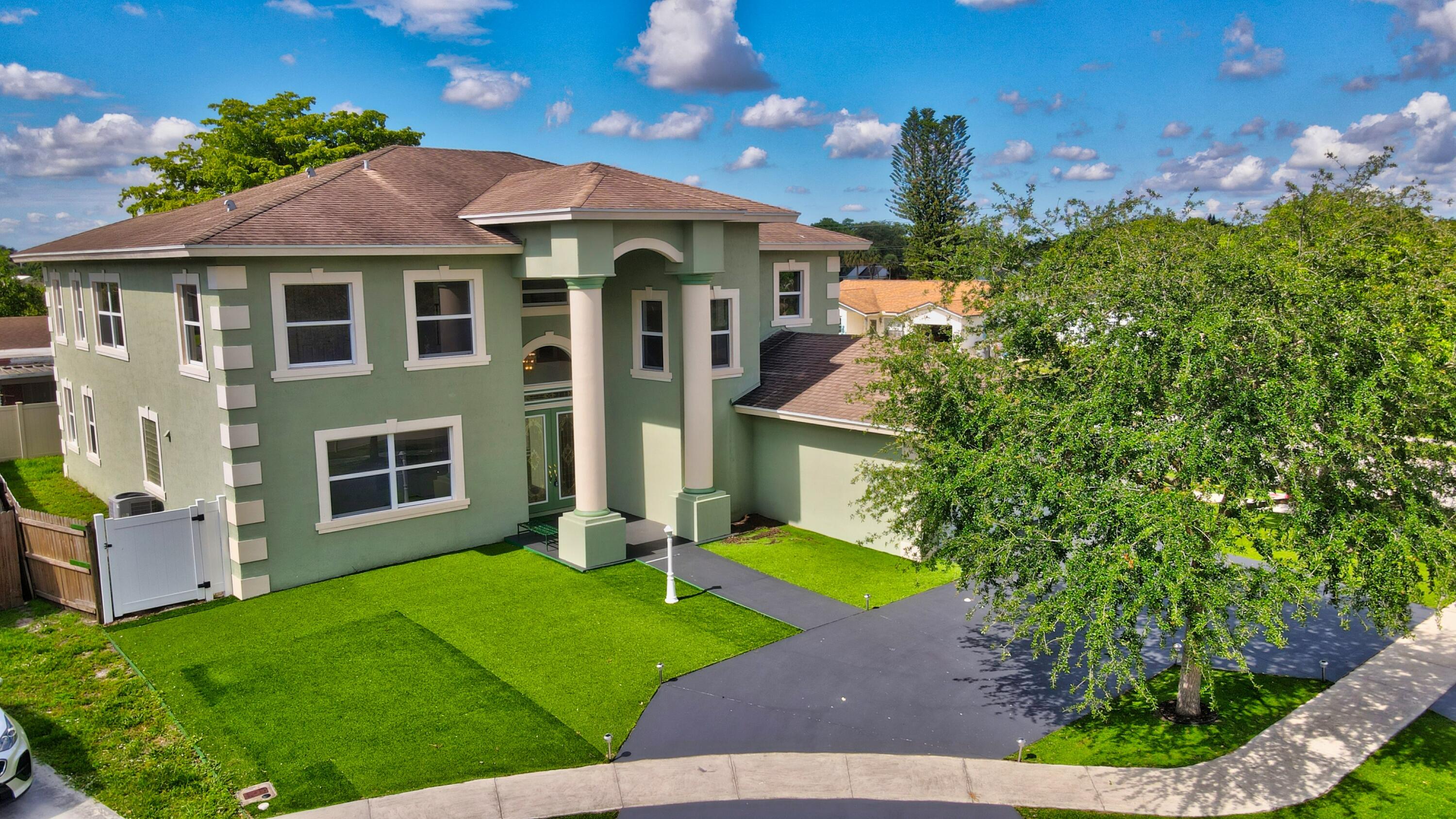 9058 Southwest 4th Street Boca Raton, FL 33433 - Photo 44 of 53 a front view of a house with a yard