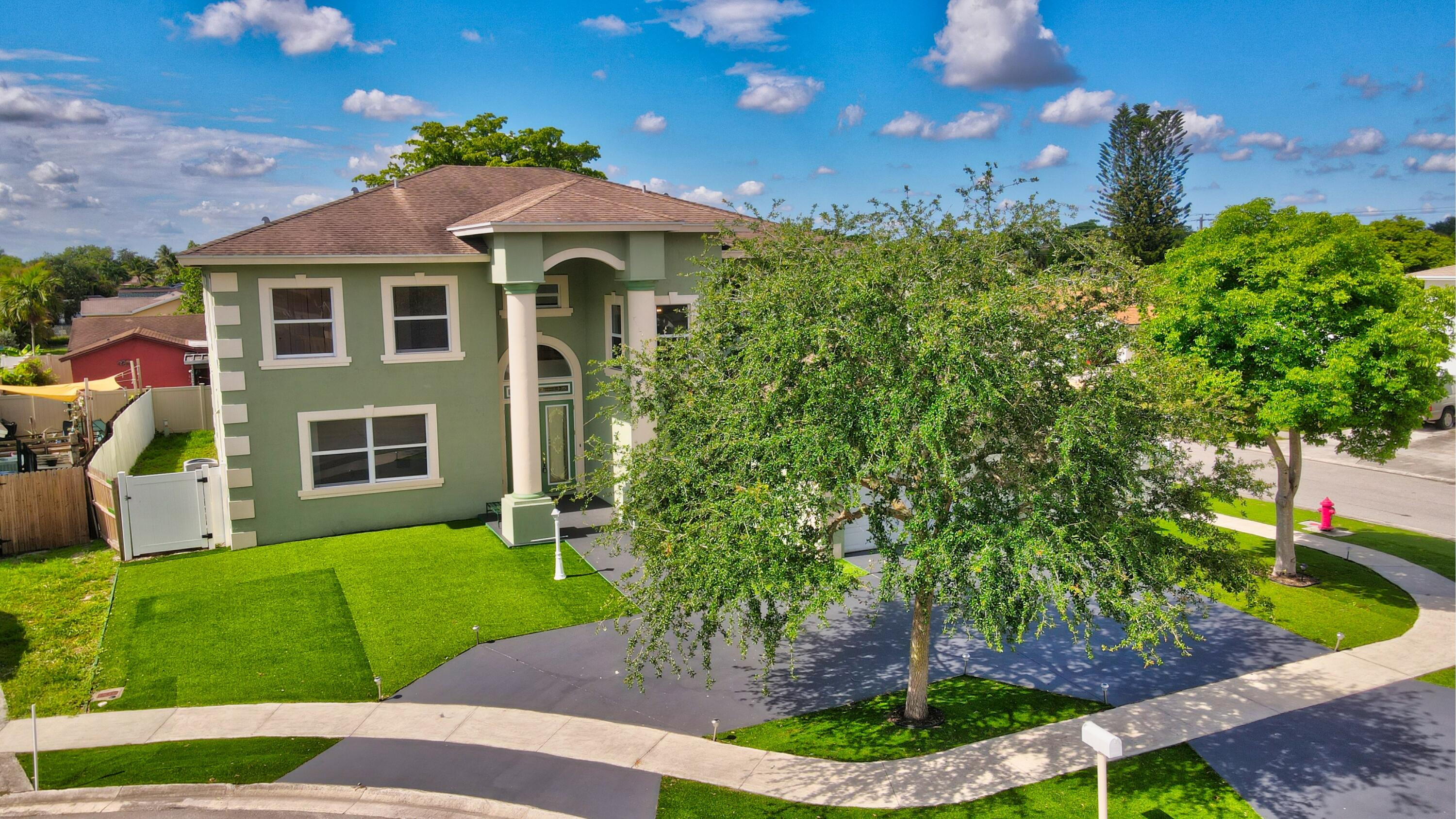 9058 Southwest 4th Street Boca Raton, FL 33433 - Photo 45 of 53 a front view of a house with a yard