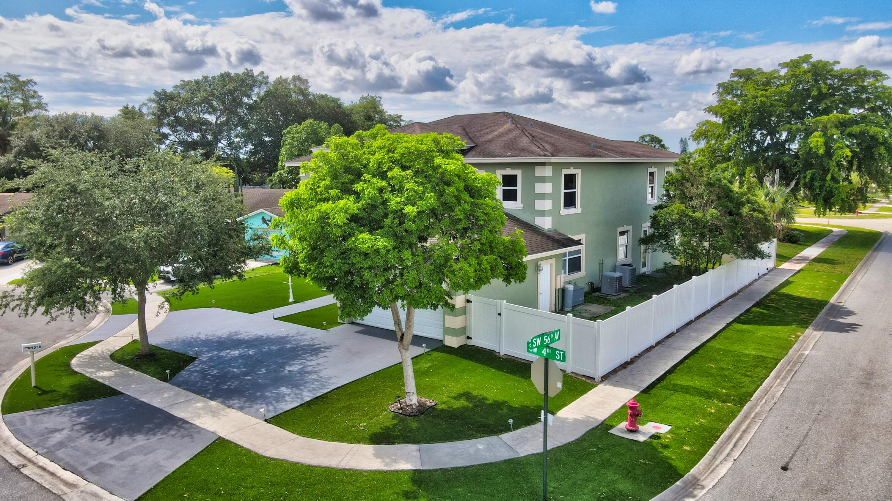9058 Southwest 4th Street Boca Raton, FL 33433 - Photo 49 of 53 a view of a house with a yard and potted plants