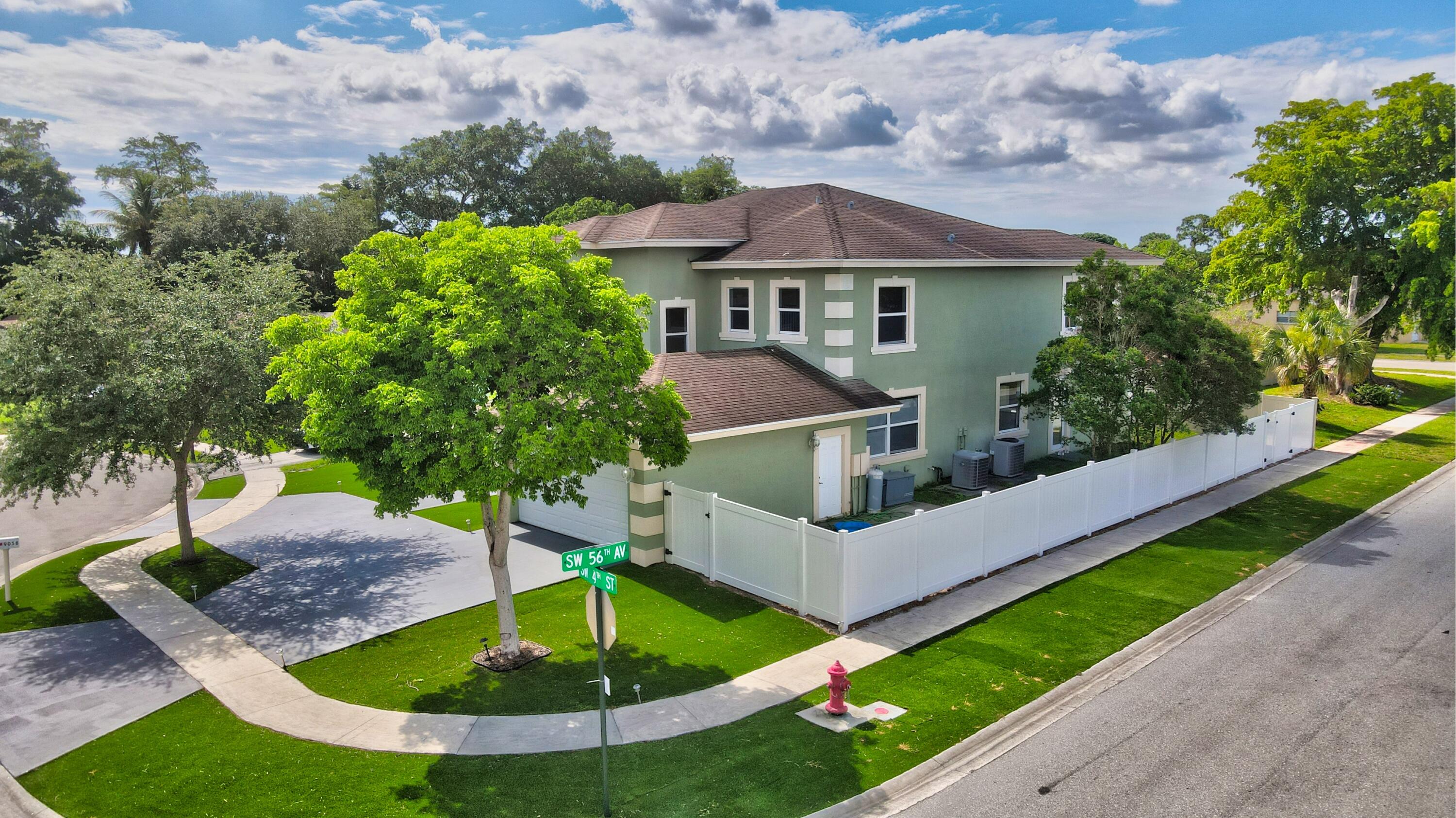9058 Southwest 4th Street Boca Raton, FL 33433 - Photo 50 of 53 a front view of a house with a yard