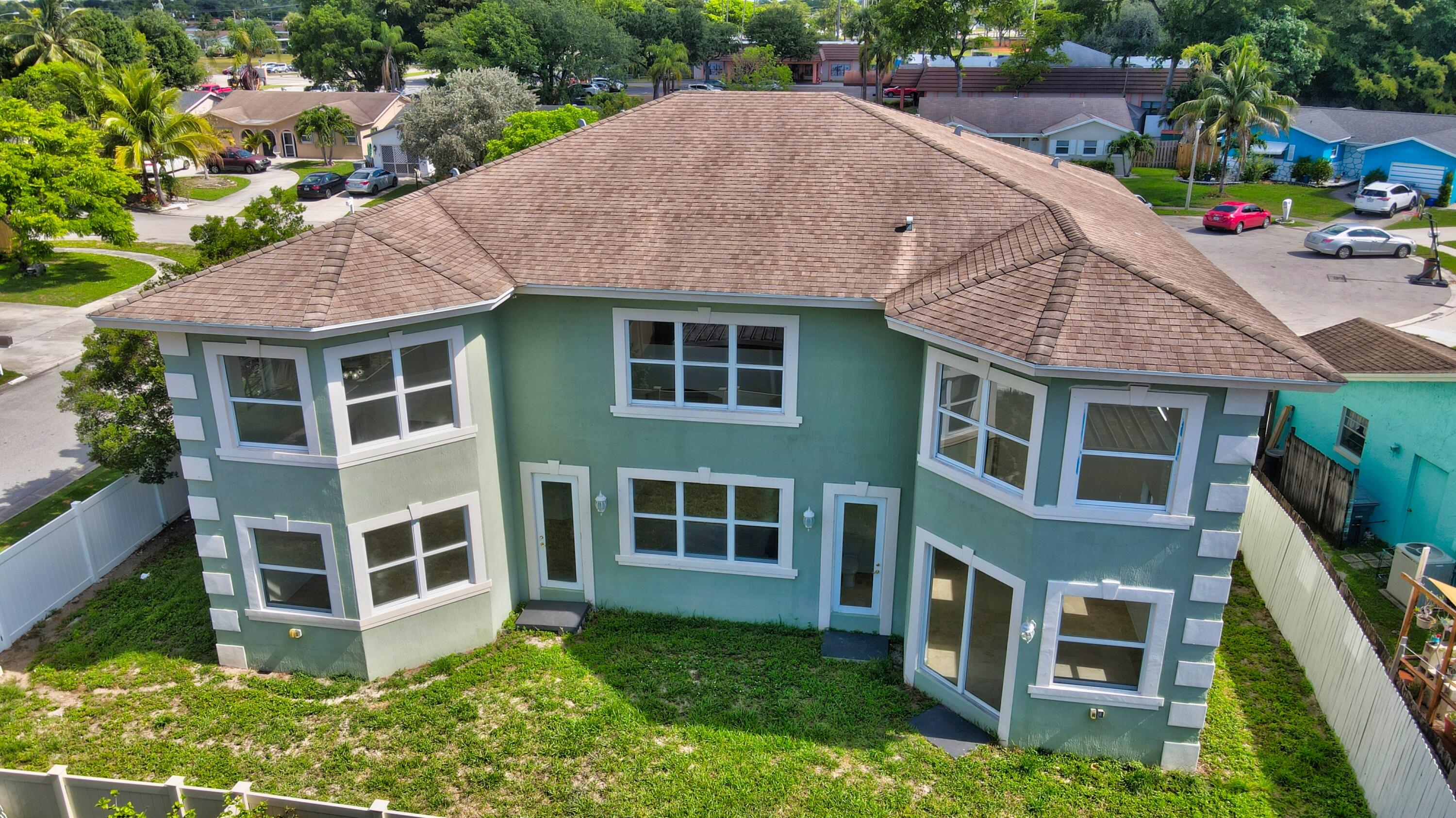 9058 Southwest 4th Street Boca Raton, FL 33433 - Photo 51 of 53 a front view of a house with a yard