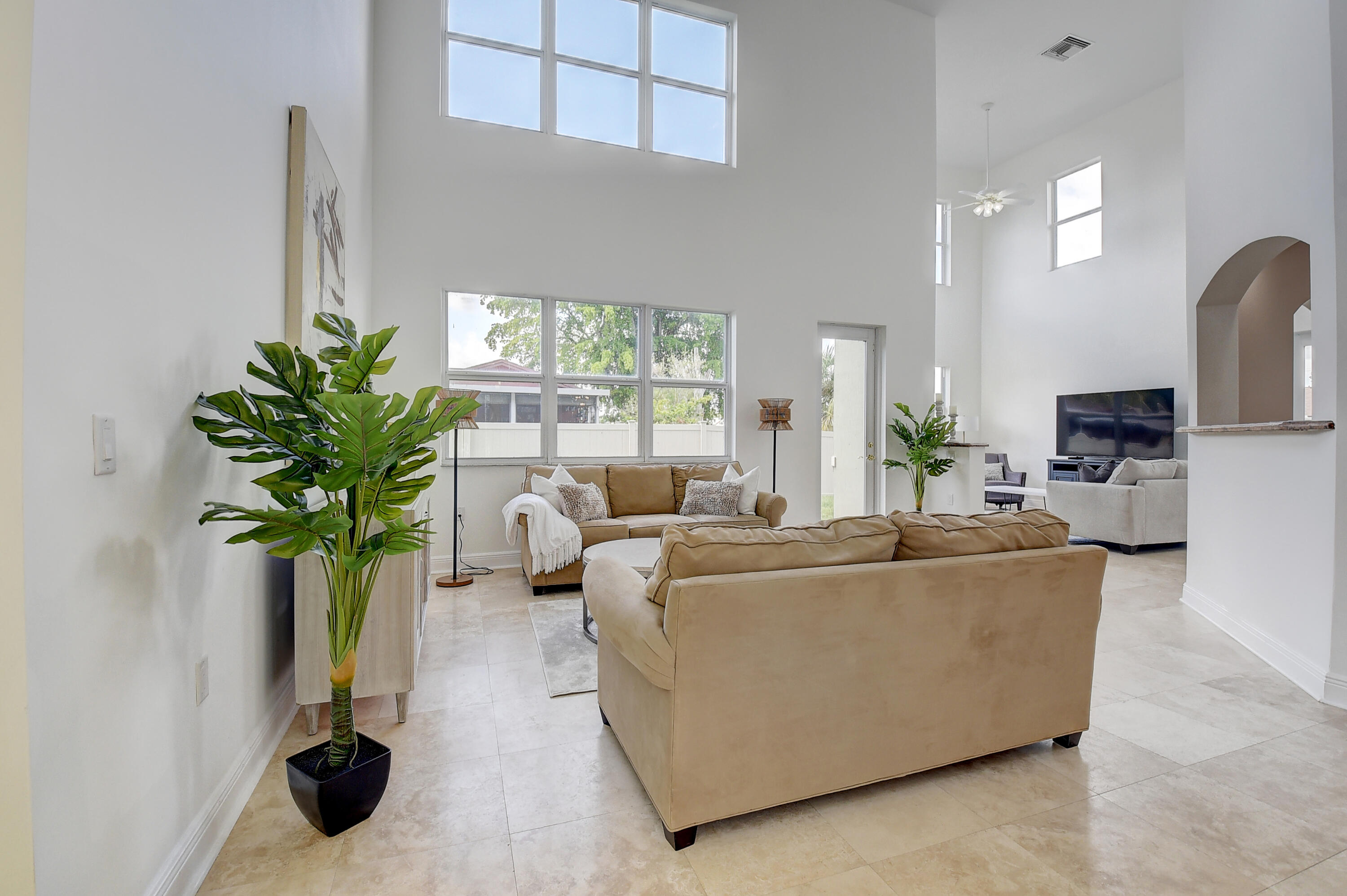 9058 Southwest 4th Street Boca Raton, FL 33433 - Photo 8 of 53 a living room with furniture potted plant and a window