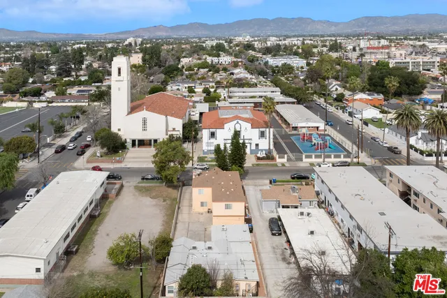an aerial view of a house with a yard and lake view