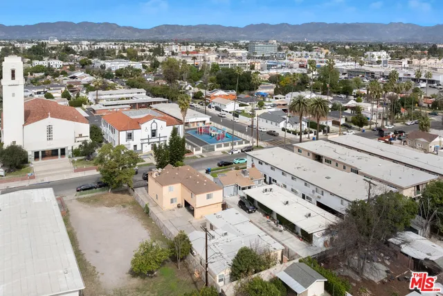 an aerial view of residential houses with outdoor space