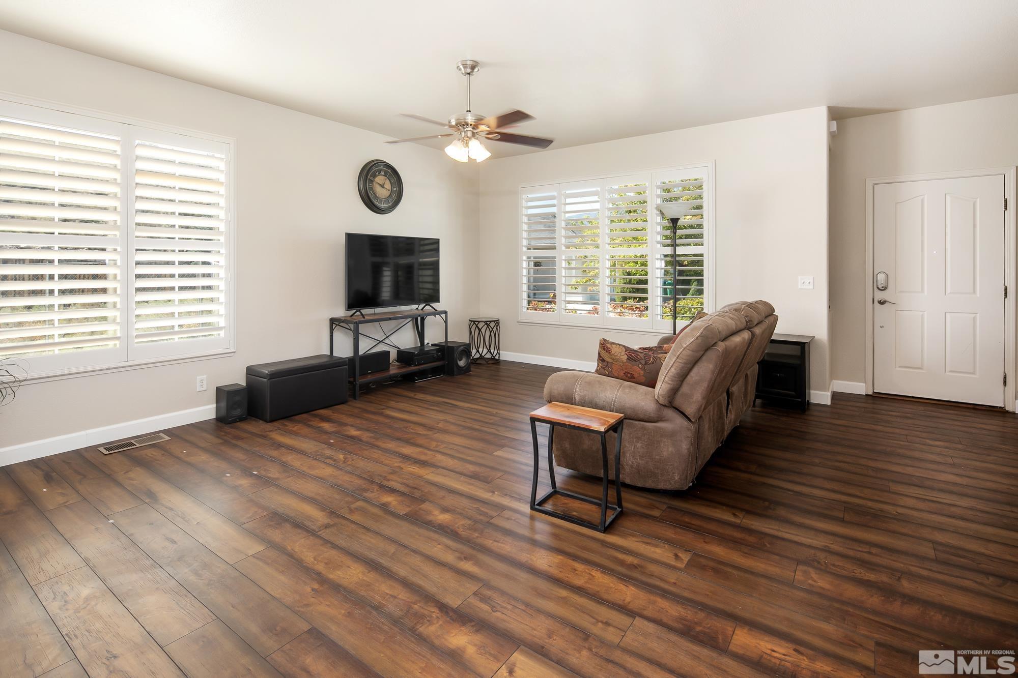 5459 Zeppelin Court Reno, NV 89523 - Photo 5 of 36 a living room with furniture wooden floor and a fireplace