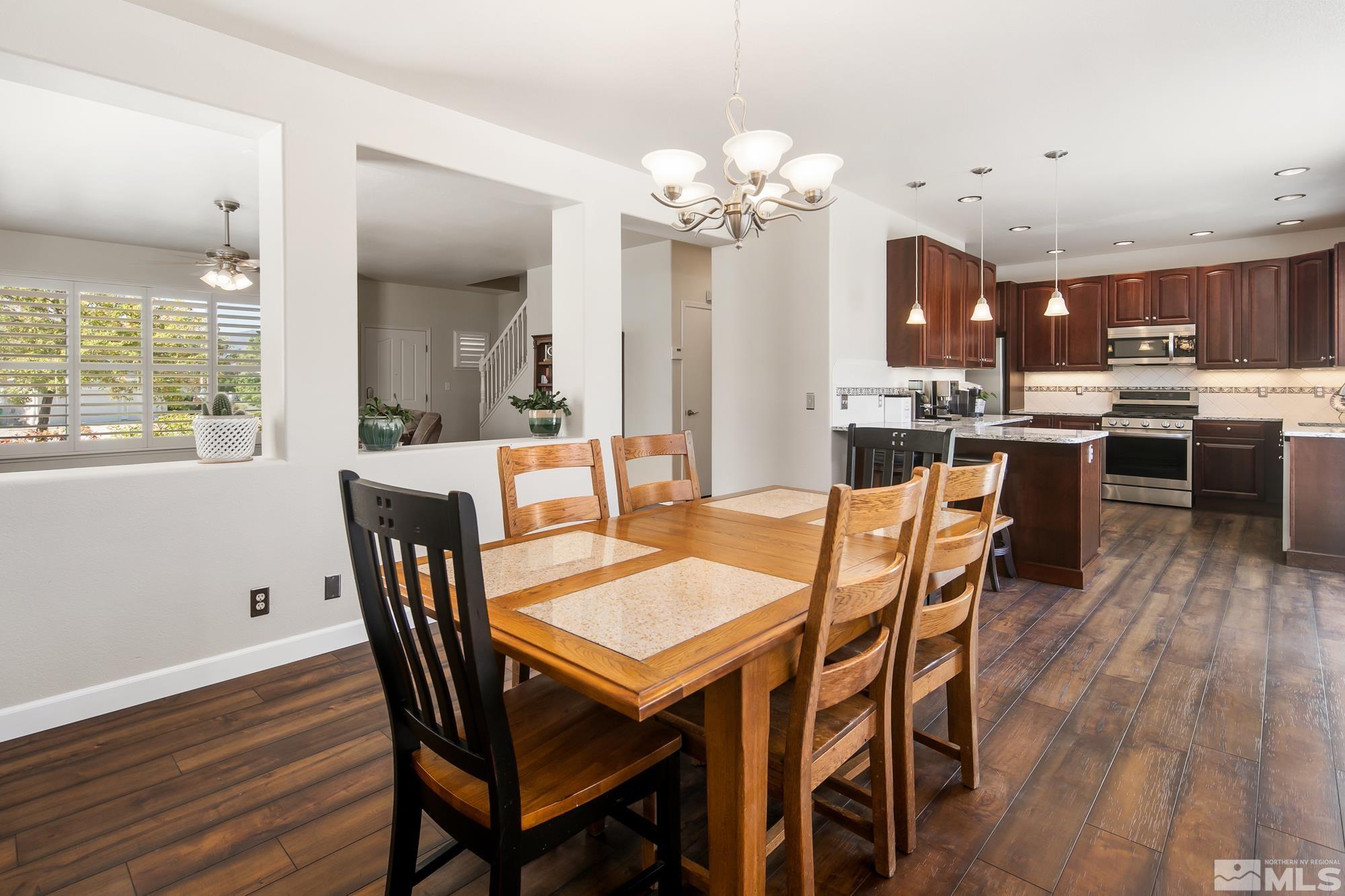 5459 Zeppelin Court Reno, NV 89523 - Photo 8 of 36 a view of a dining room with furniture window and wooden floor
