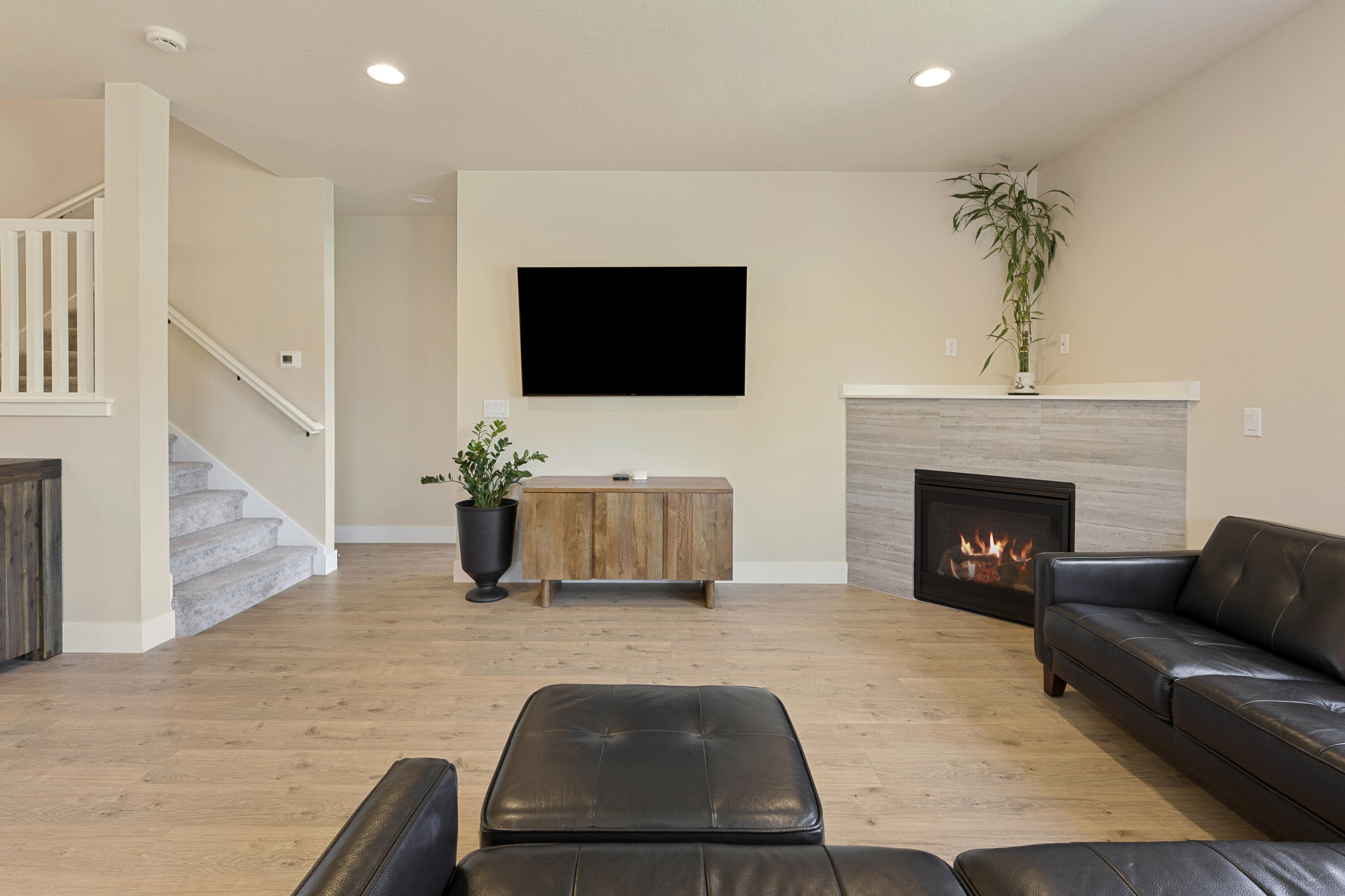 4999 Southwest Yew Place Redmond, OR 97756 - Photo 17 of 50 a living room with furniture a fireplace and a flat screen tv