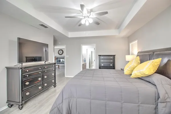a bedroom with a bed and a television