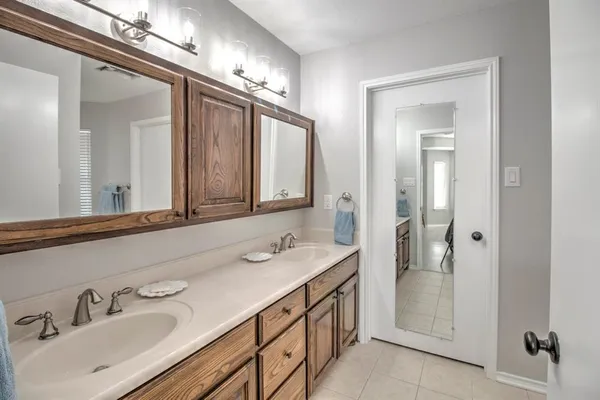 a bathroom with a sink double vanity and a mirror
