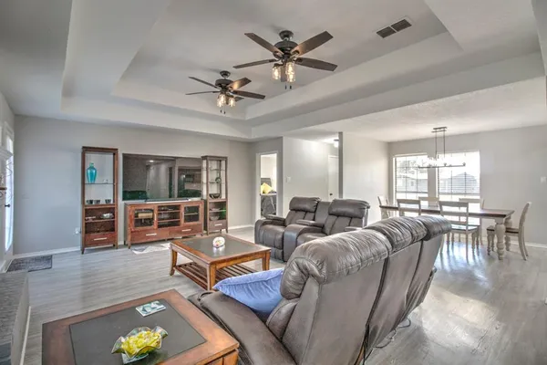 a living room with furniture fireplace and a large window
