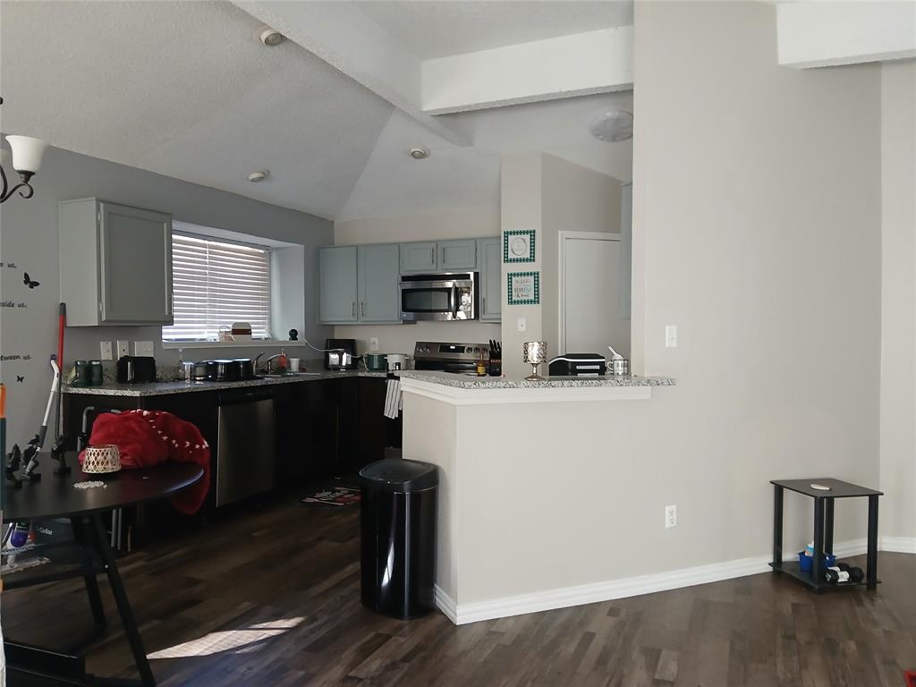 5002 South Prairieview Arlington, TX 76017 - Photo 2 of 11 a kitchen with a refrigerator and a stove top oven