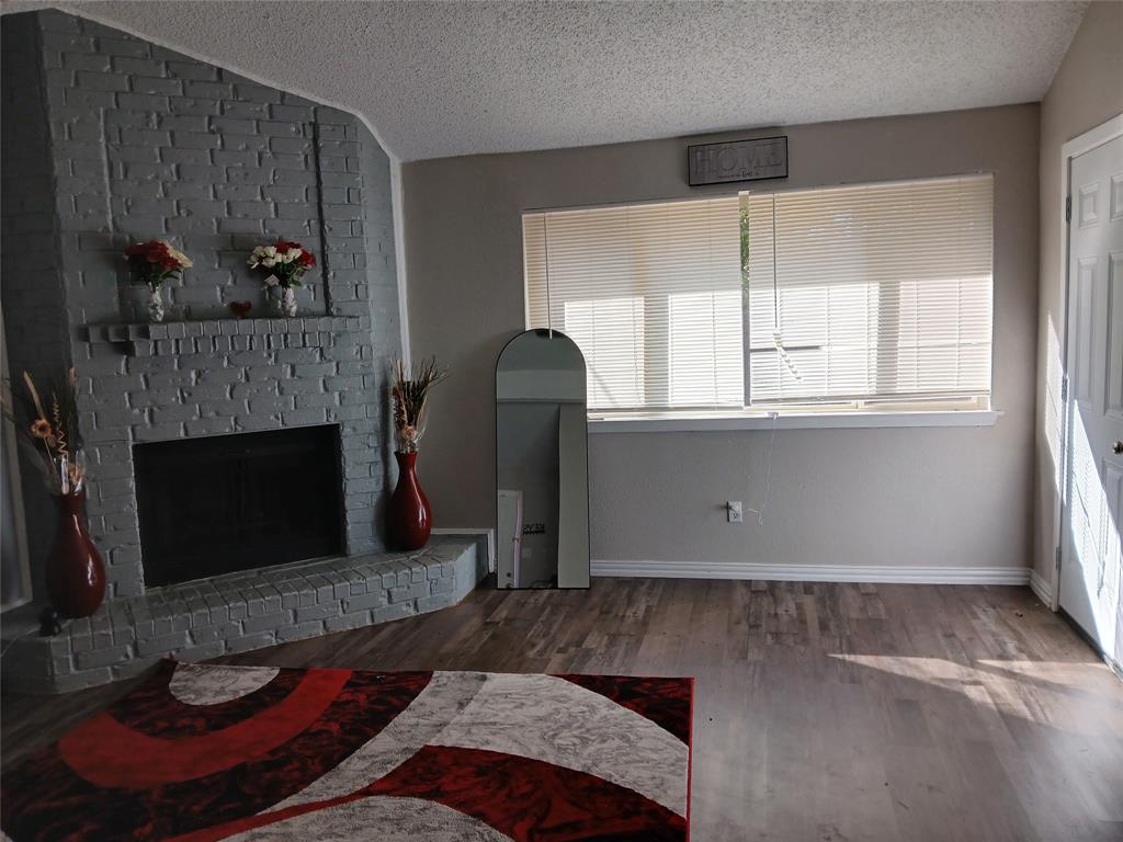 5002 South Prairieview Arlington, TX 76017 - Photo 4 of 11 a living room with furniture and a fireplace