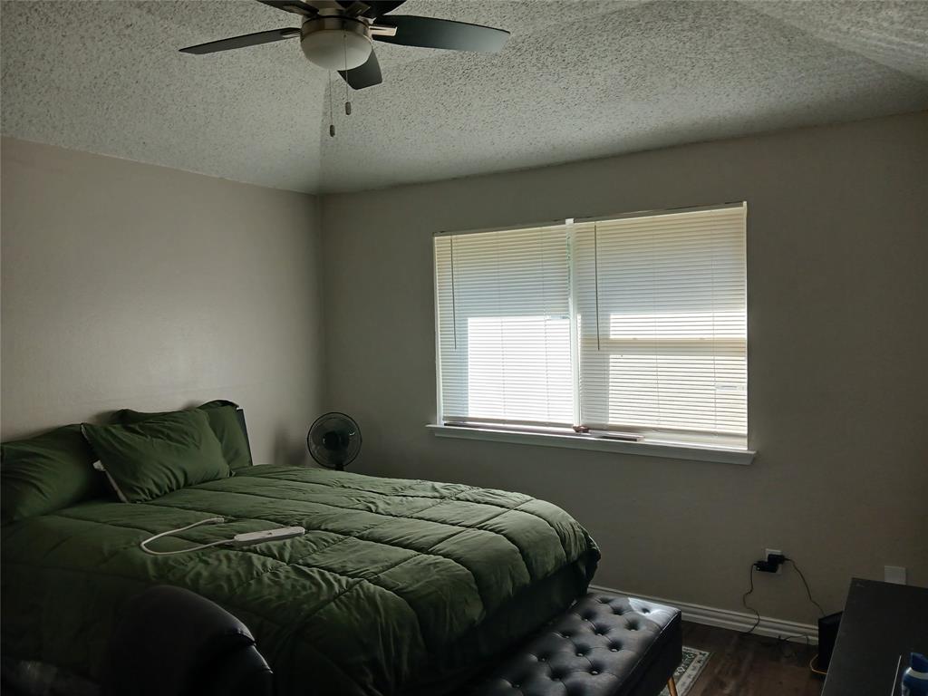 5002 South Prairieview Arlington, TX 76017 - Photo 7 of 11 a bedroom with a bed and window