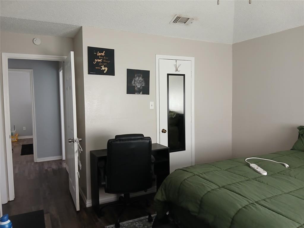 5002 South Prairieview Arlington, TX 76017 - Photo 8 of 11 a bedroom that has a bed and a chair in it