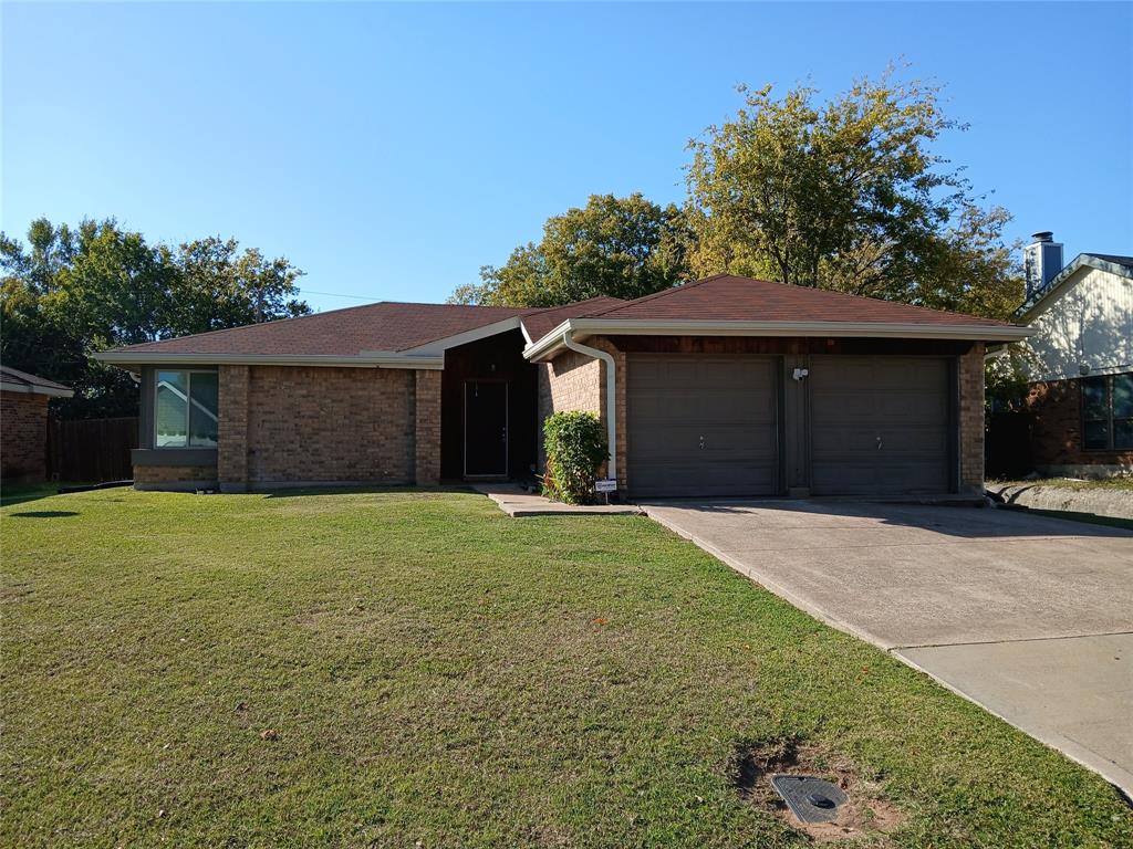 5002 South Prairieview Arlington, TX 76017 - Photo 10 of 11 a front view of a house with a yard and garage