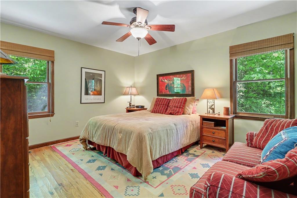 102 Moses Road Rabun Gap, GA 30568 - Photo 17 of 40 a bedroom with a bed and wooden floor