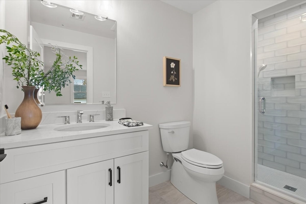 24 Jayne Road Needham, MA 02494 - Photo 20 of 34 a bathroom with a toilet sink and mirror