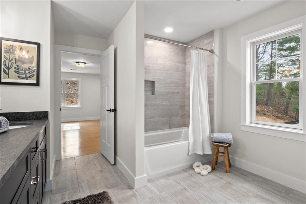 24 Jayne Road Needham, MA 02494 - Photo 21 of 34 a bathroom with a granite countertop sink a mirror and a shower