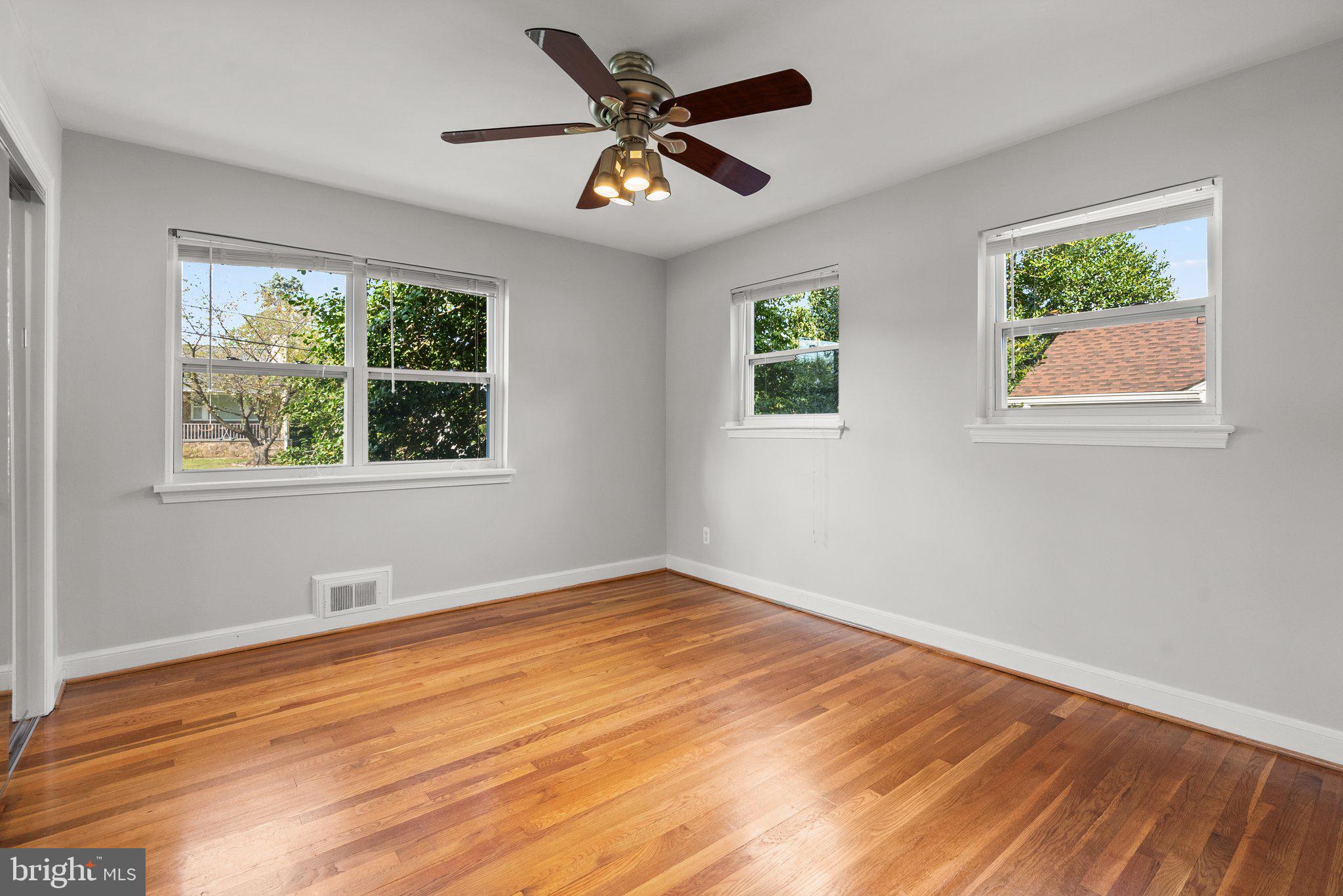 2206 Darrow Street Silver Spring, MD 20902 - Photo 13 of 31 a view of an empty room with wooden floor and a window