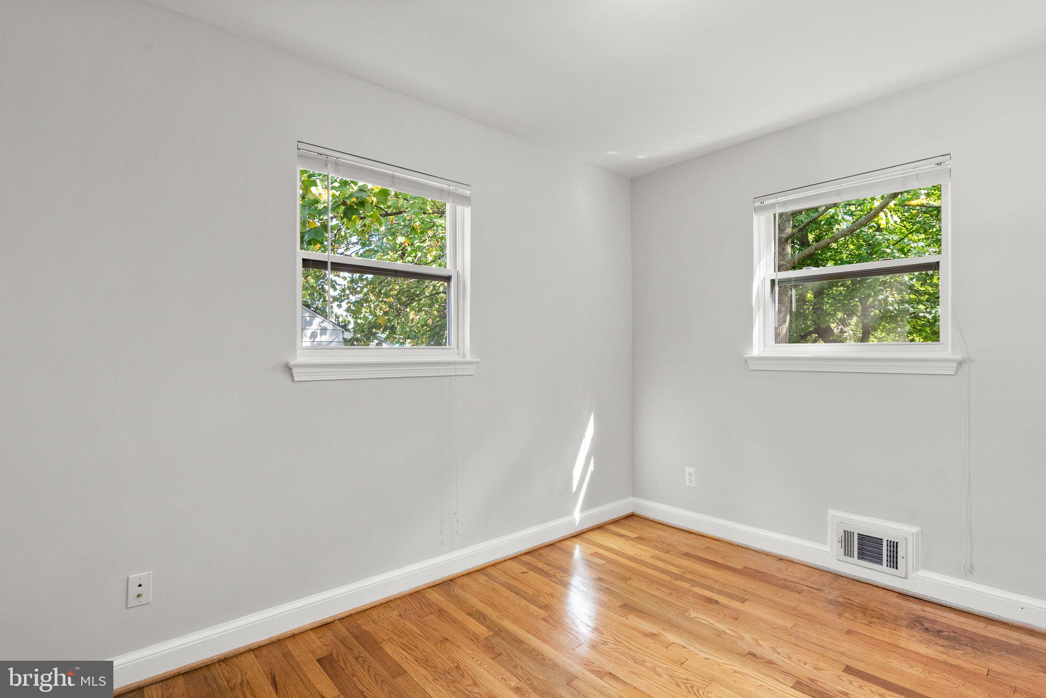 2206 Darrow Street Silver Spring, MD 20902 - Photo 19 of 31 a view of an empty room with wooden floor and a window