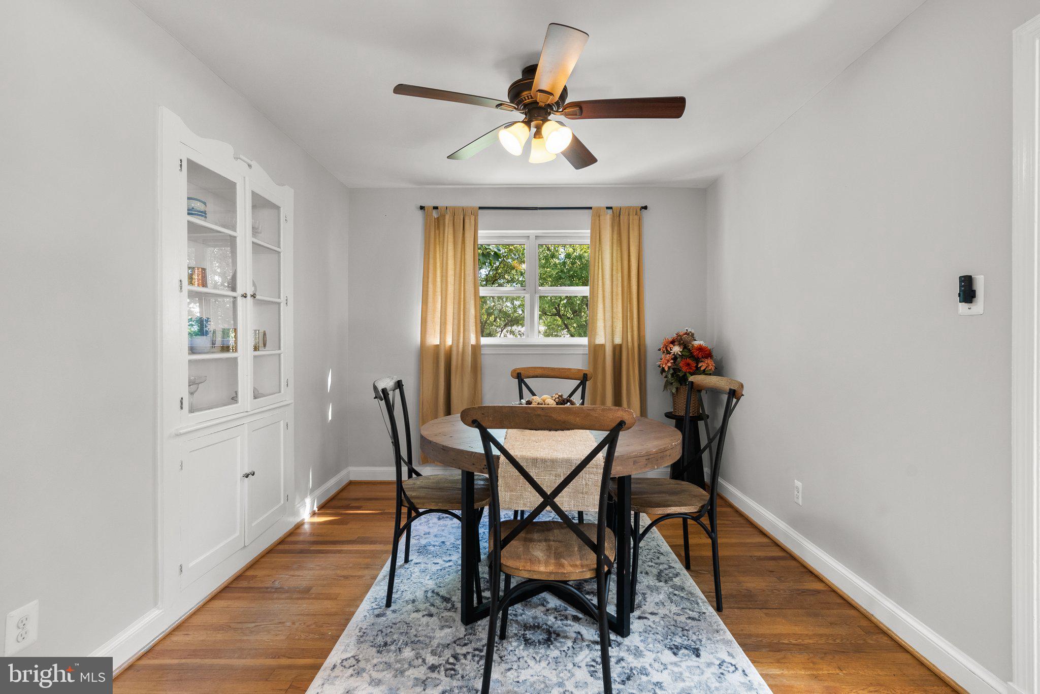 2206 Darrow Street Silver Spring, MD 20902 - Photo 7 of 31 a dining room with furniture a chandelier and wooden floor